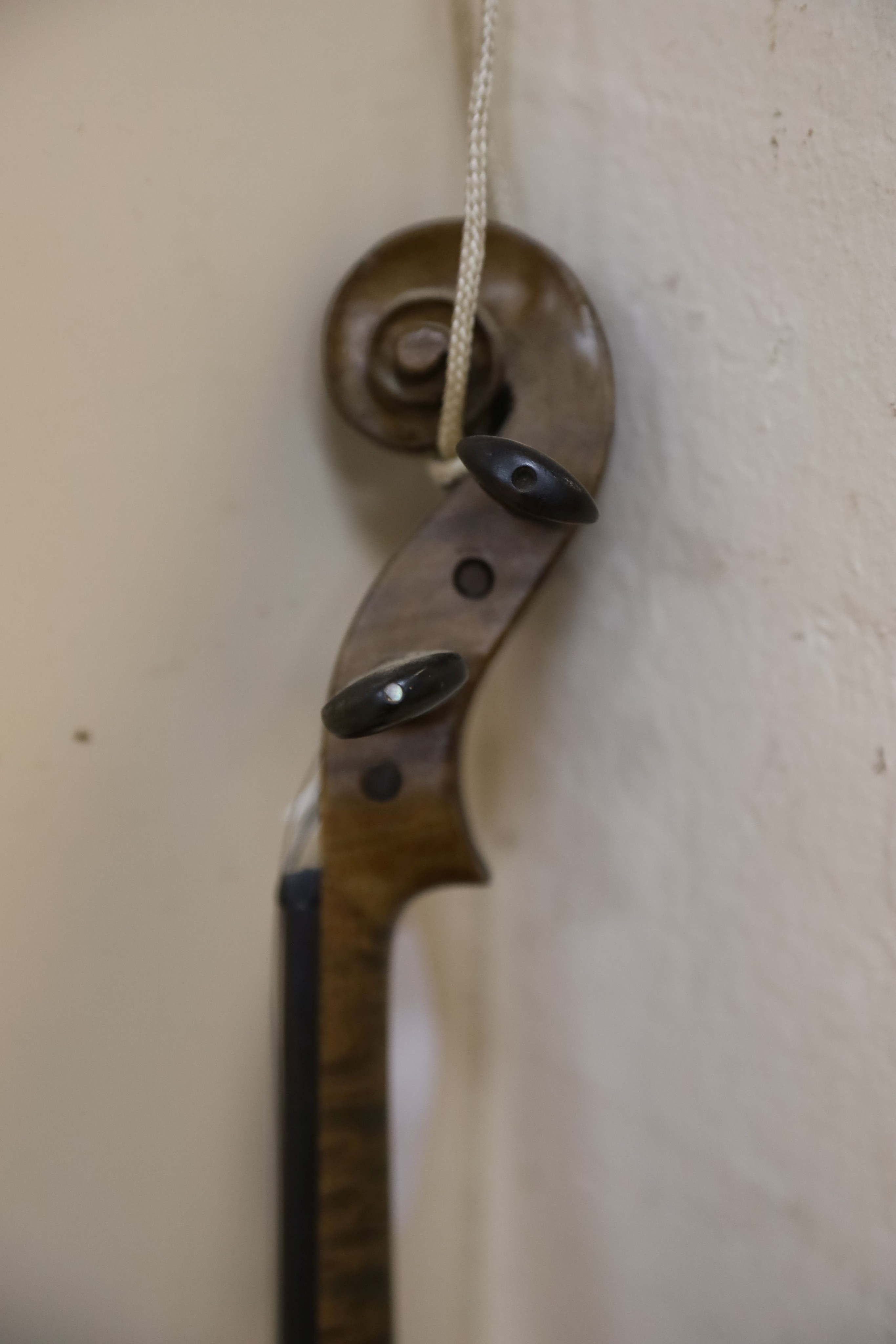 A violin labelled Francesco Ruggeri and a bow. Back of violin excluding button - 36cm